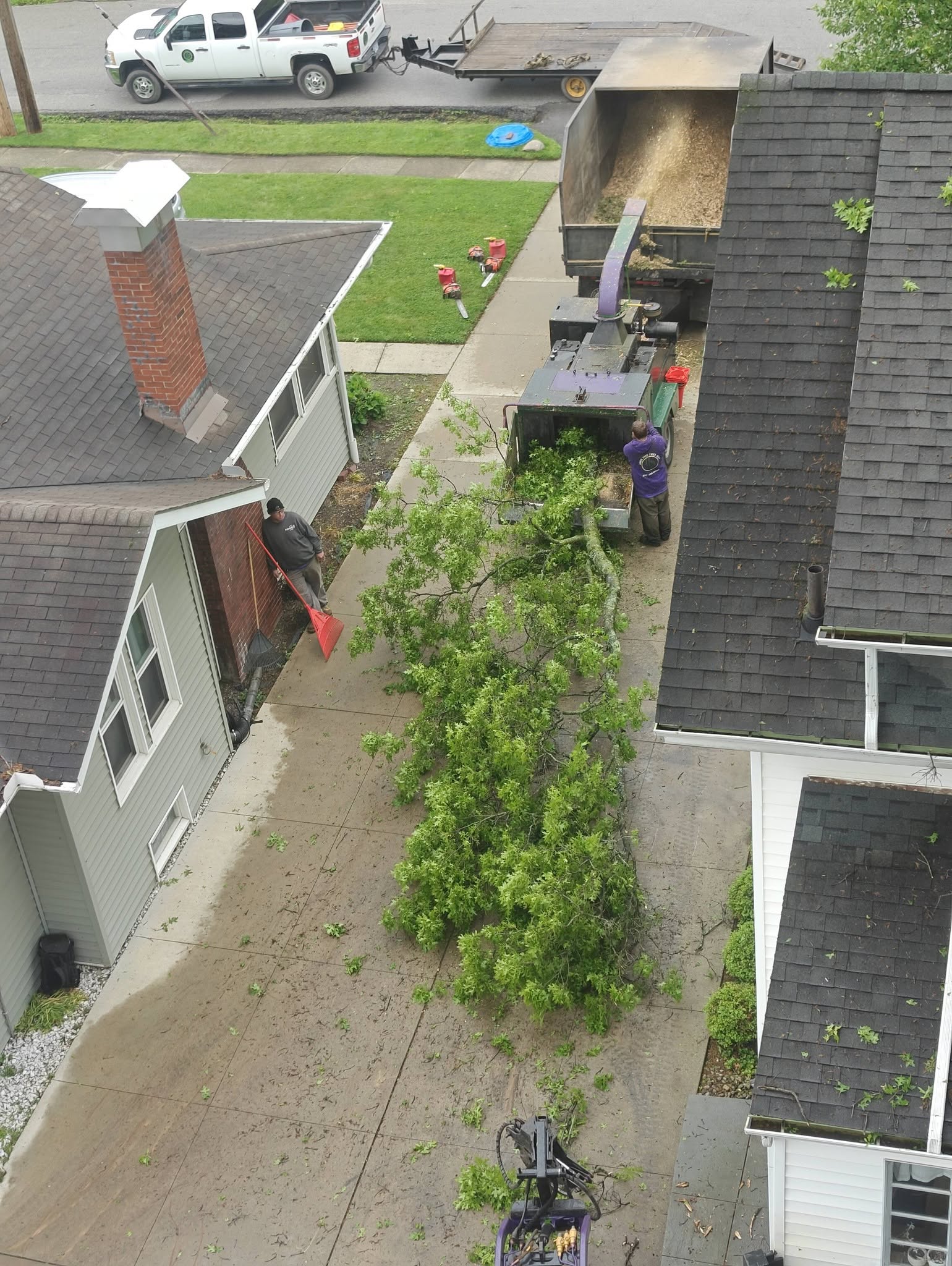 Aerial view of crew working between houses